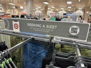 Clothing rack in store displaying a QR code